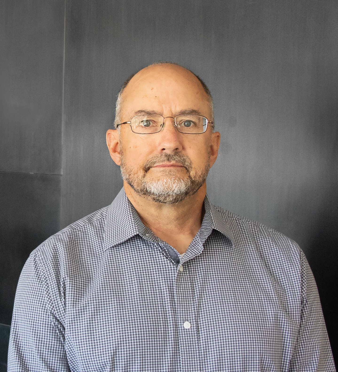 Man with glasses in a gray shirt