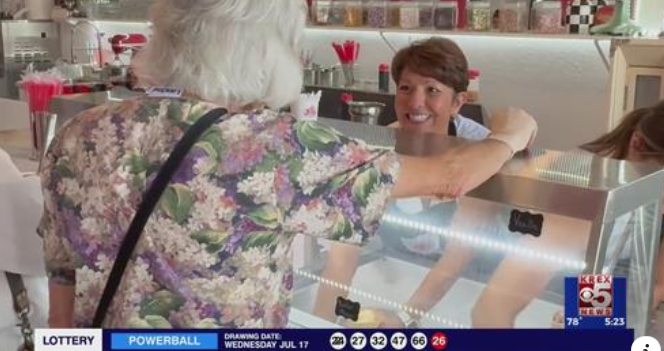 Woman with shoert brown hair smiling at an older woman over an ice cream counter