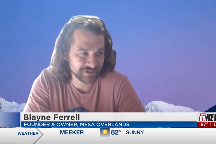 Man with beard and brown hair in a pink tshirt