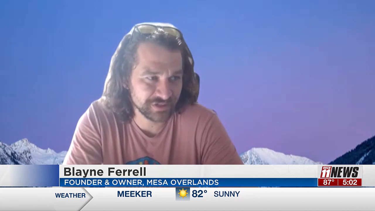 Man with beard and brown hair in a pink tshirt